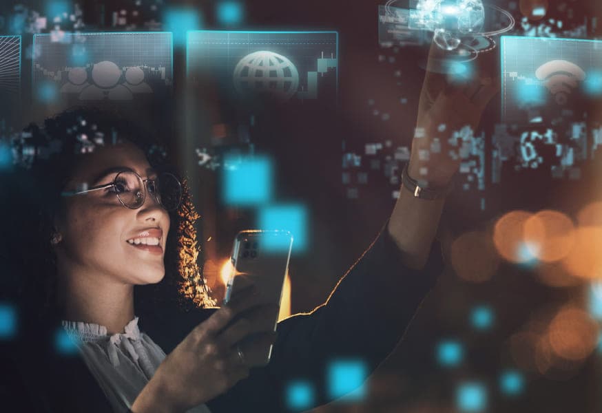 A woman holding a phone and working on a digital smart display