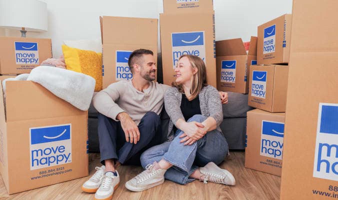 happy couple in the middle of moving boxes