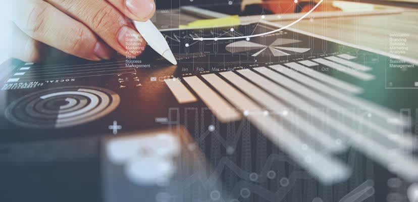 screen-with-line-graph-and-hand-holding-pen