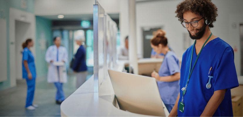 Nurse in a hospital working behind the desk talking on a headset