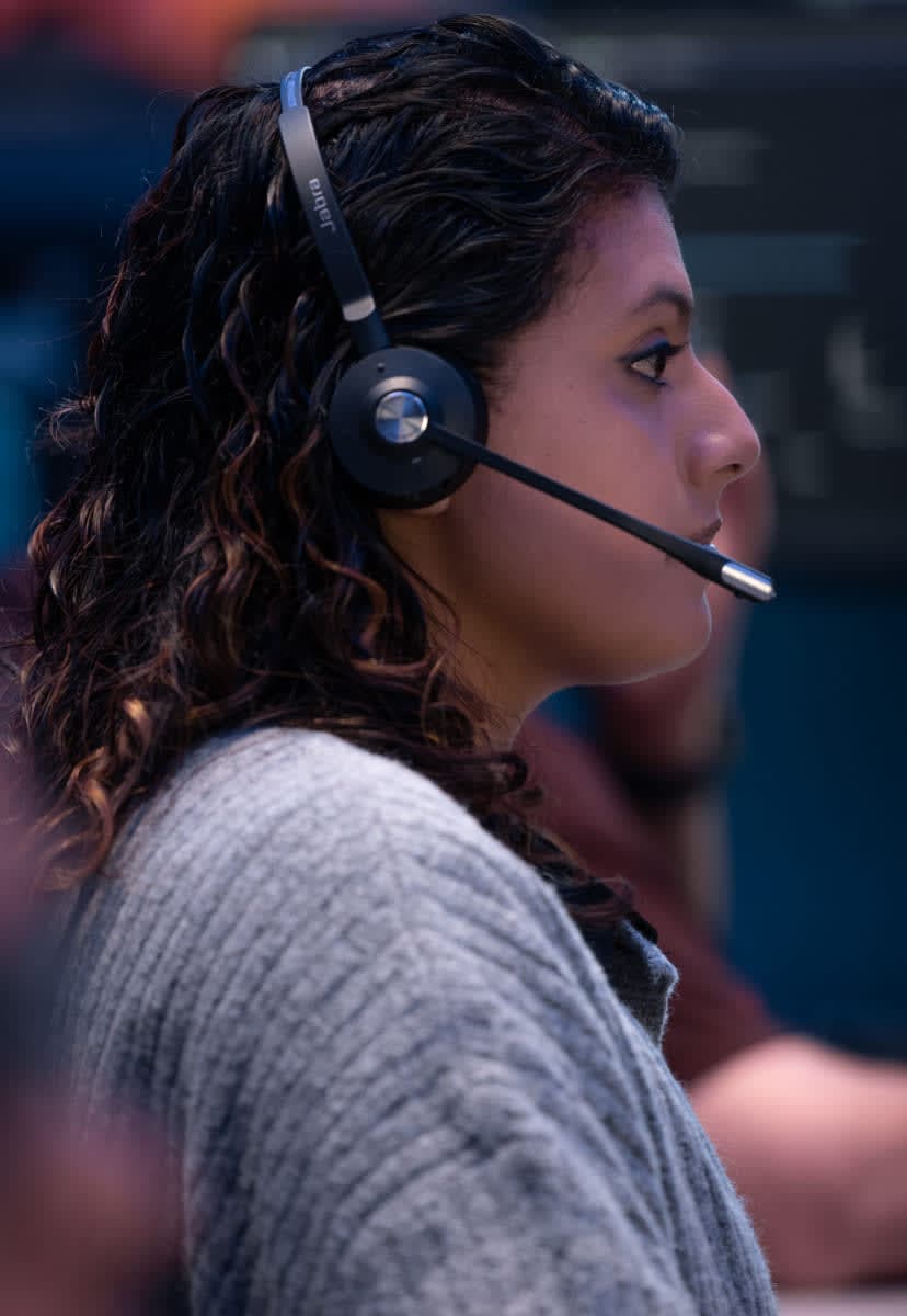 Woman wearing a headset sitting at a computer