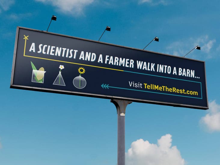 A billboard that says “A scientist and a farmer walk into a barn... Visit TellMeTheRest.com”
