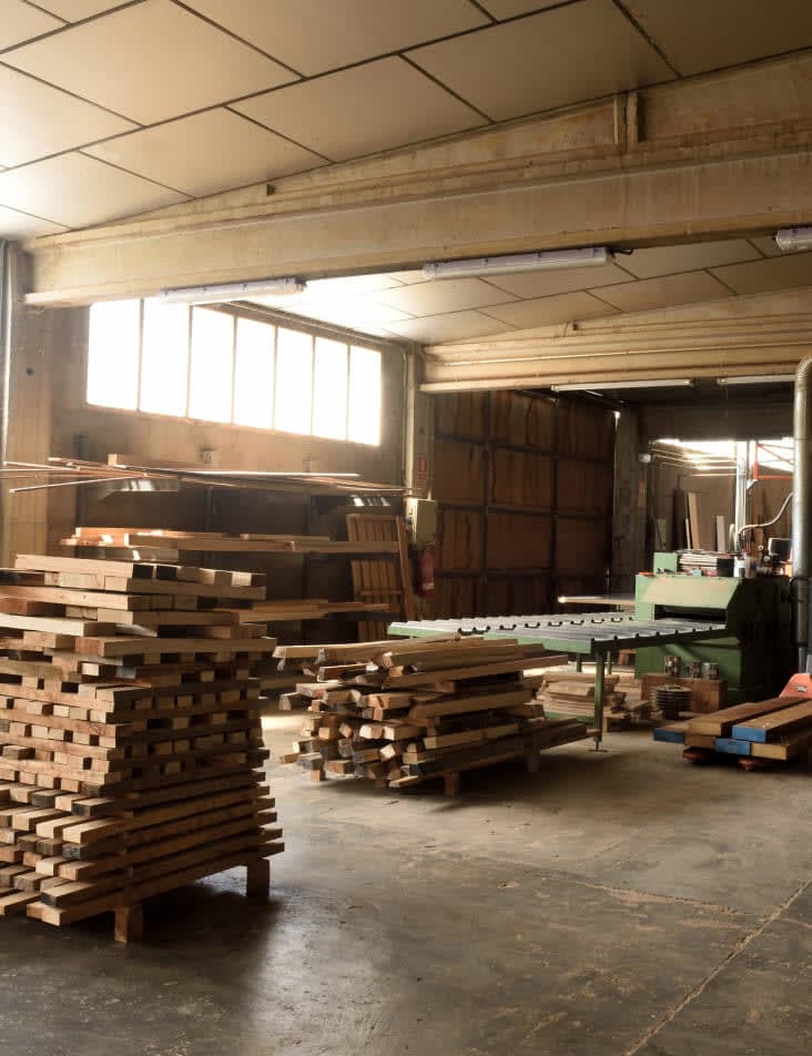 warehouse full of wood and pallets and machinery