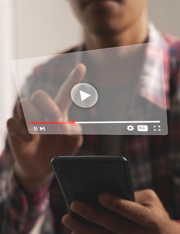 Person pressing play on a video
