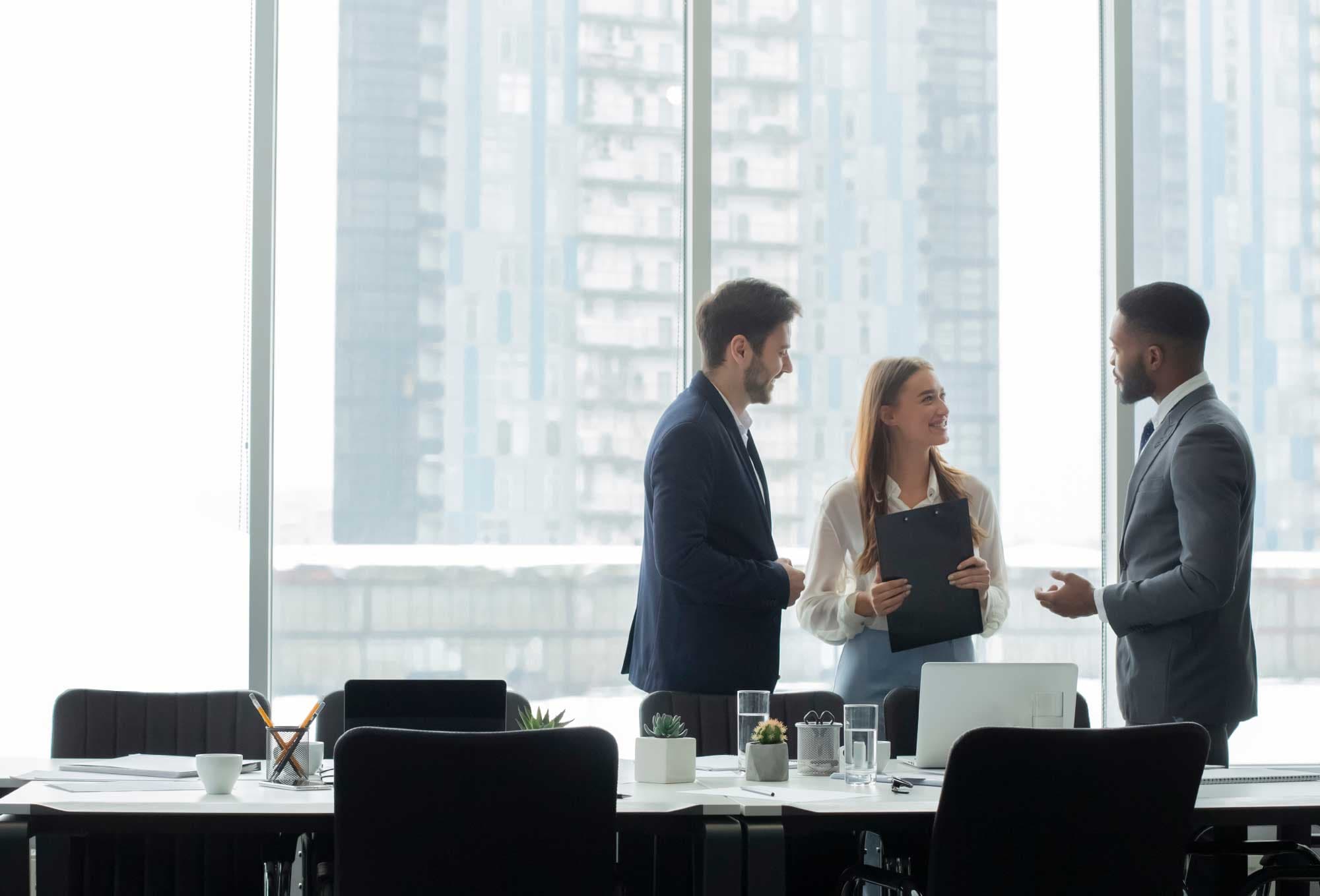 CFOs having a meeting in an office with a view of buildings | Tech CFOs Need to Maximize Their 2023 Budget