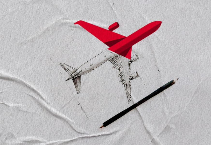 A wrinkled background with a plane half in greyscale and half red